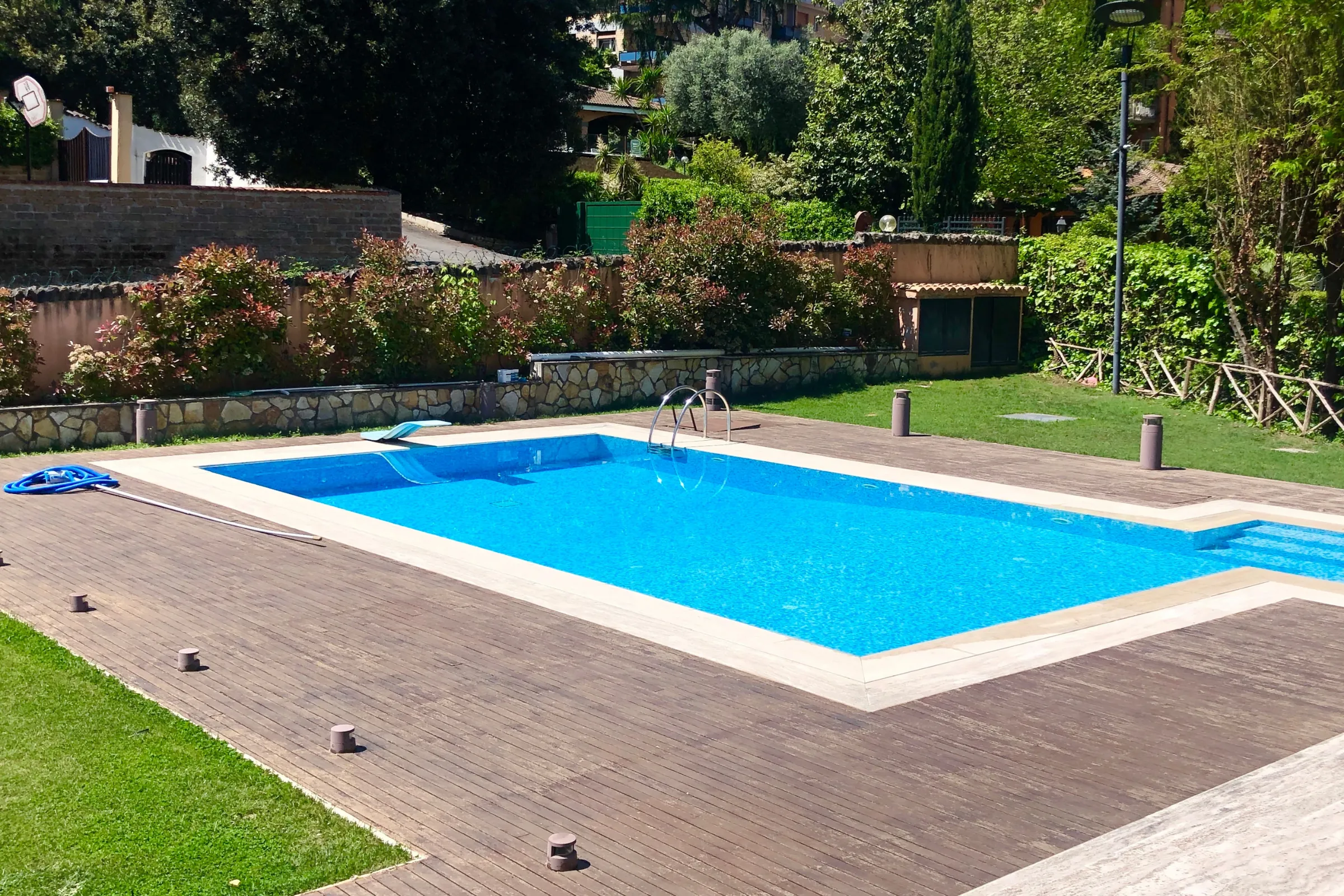 Before backyard remodeling project in Los Angeles showing outdated pool deck, worn hardscape, limited outdoor seating, older patio layout, and backyard renovation potential
