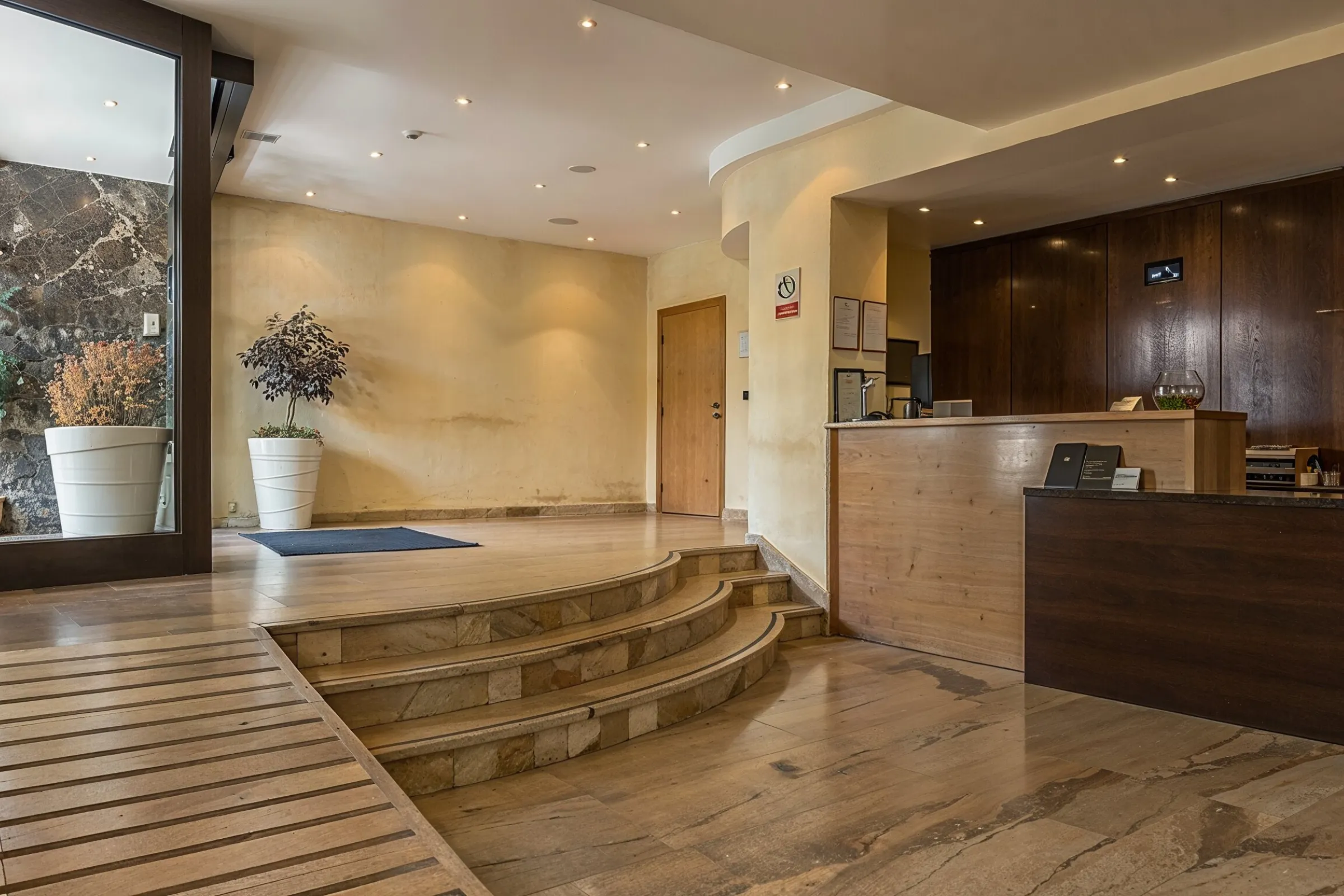 Before commercial remodeling project in Los Angeles showing outdated lobby interior, worn reception finishes, dated lighting, older commercial flooring, and business renovation potential