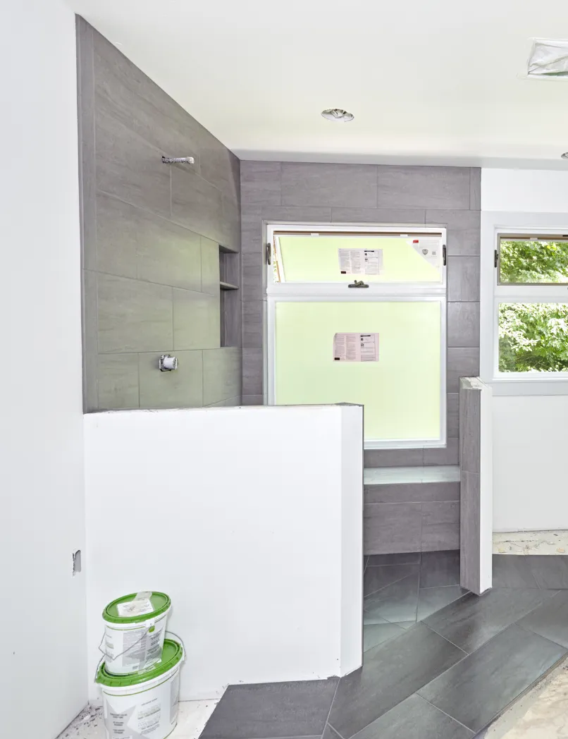 Los Angeles bathroom remodeling project with walk-in shower tile installation, modern gray wall tile, floor tile updates, and fixture preparation