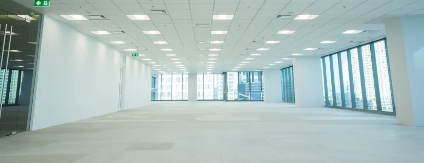 Completed commercial remodeling project in Los Angeles with open office layout, updated ceiling, bright lighting, modern flooring, and flexible business space