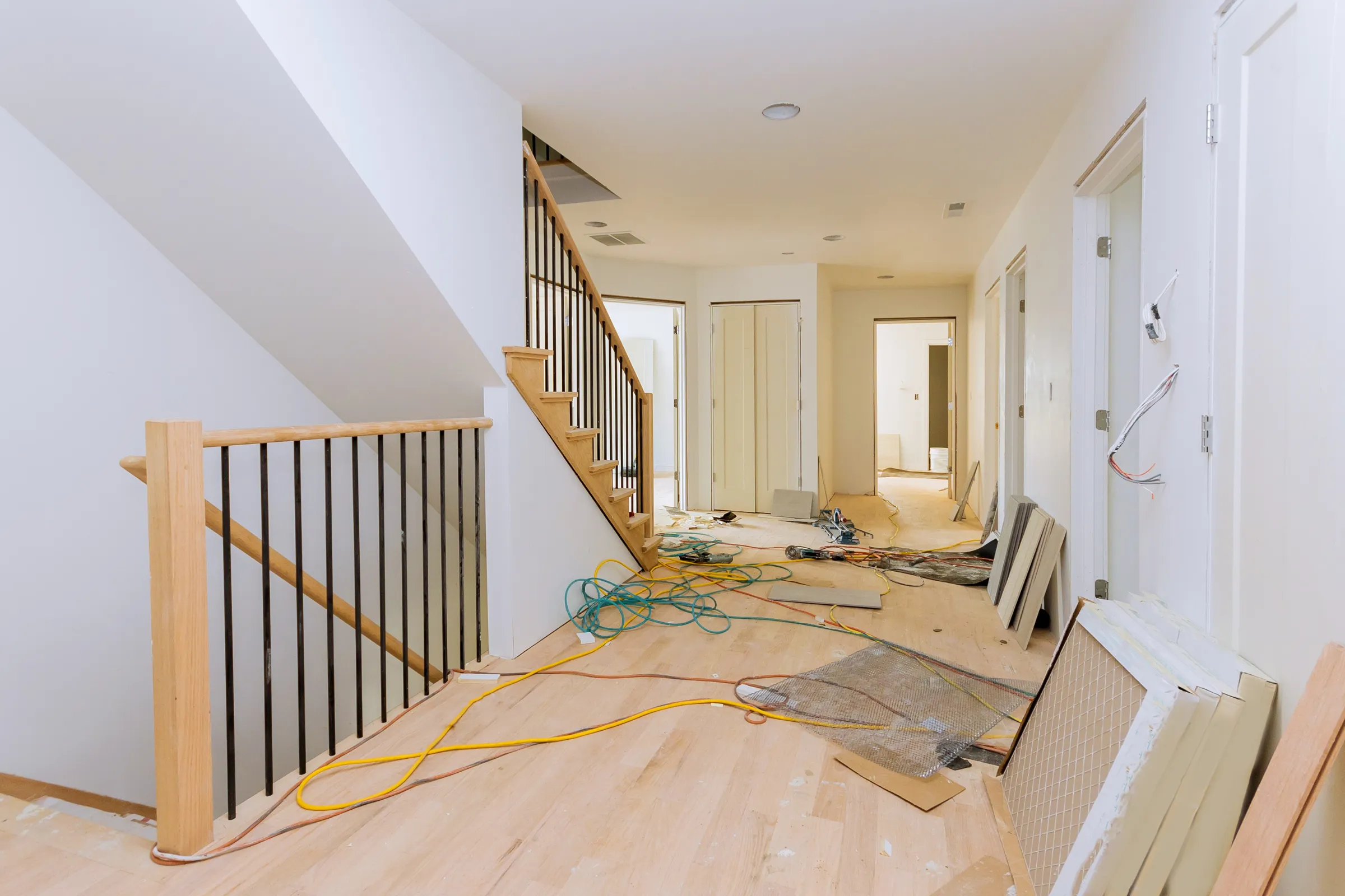 Los Angeles home remodeling interior renovation in progress with staircase updates, flooring work, electrical preparation, and open living space improvements