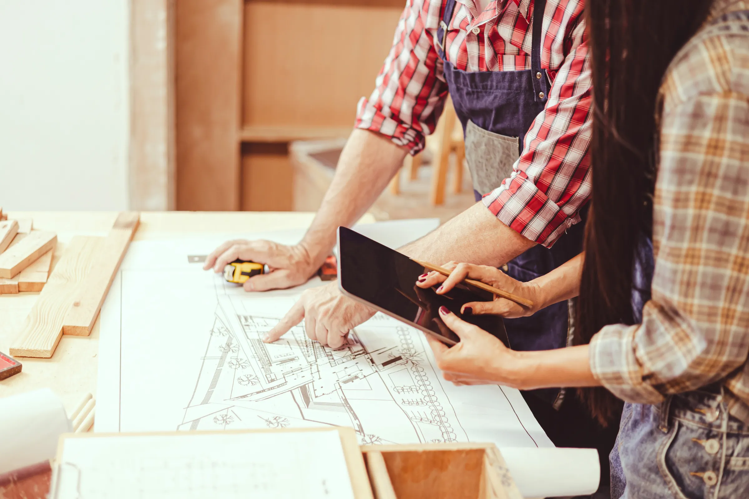 Remodeling permits and planning in Los Angeles with contractor and homeowner reviewing architectural plans, material selections, and renovation scope before construction